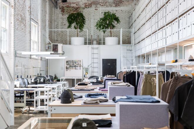 A white clothing workshop with several workbenches.