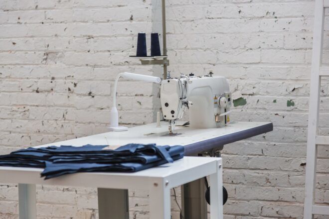 White bricks behind a white sewing machine and workbench.