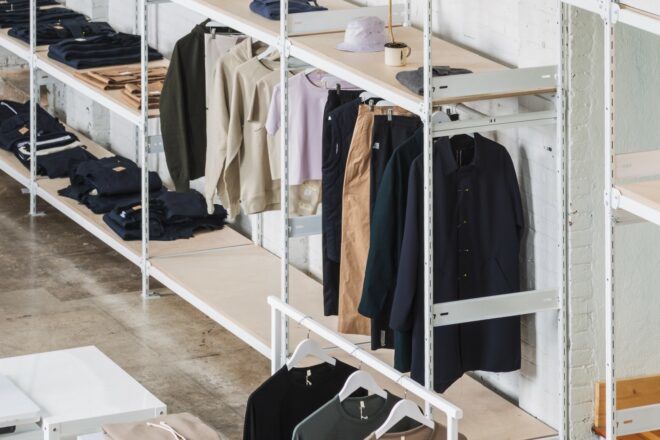 White racks of neutral-toned clothes.