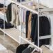 White racks of neutral-toned clothes.
