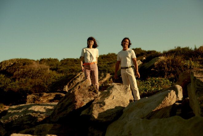two people in pastel outfits and wearing utility belts made of recycled plastic