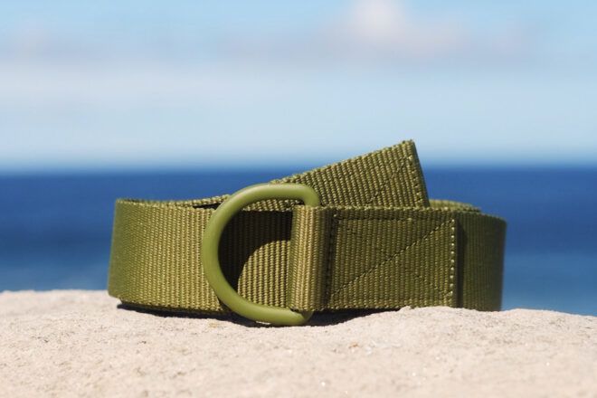 dark green utility belt on a beach