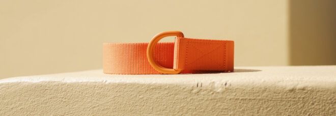orange utility belt on beige background