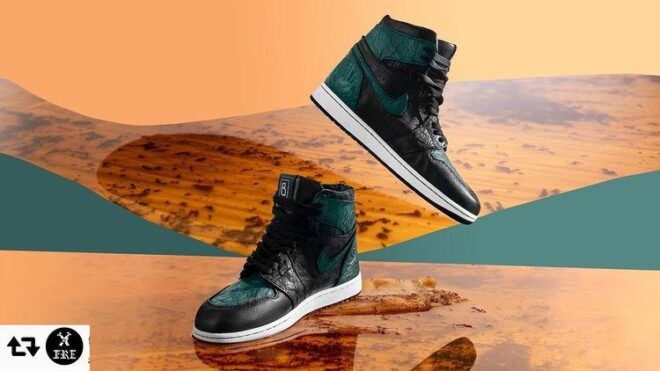A pair of dark teal sneakers against an abstract wood background.