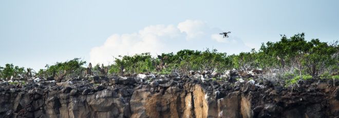 A drone flying over a rocky ledge on the Galapagos Islands.
