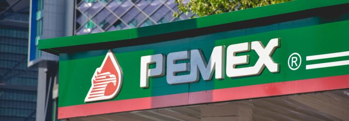The logo for Pemex on a gas station overhang.