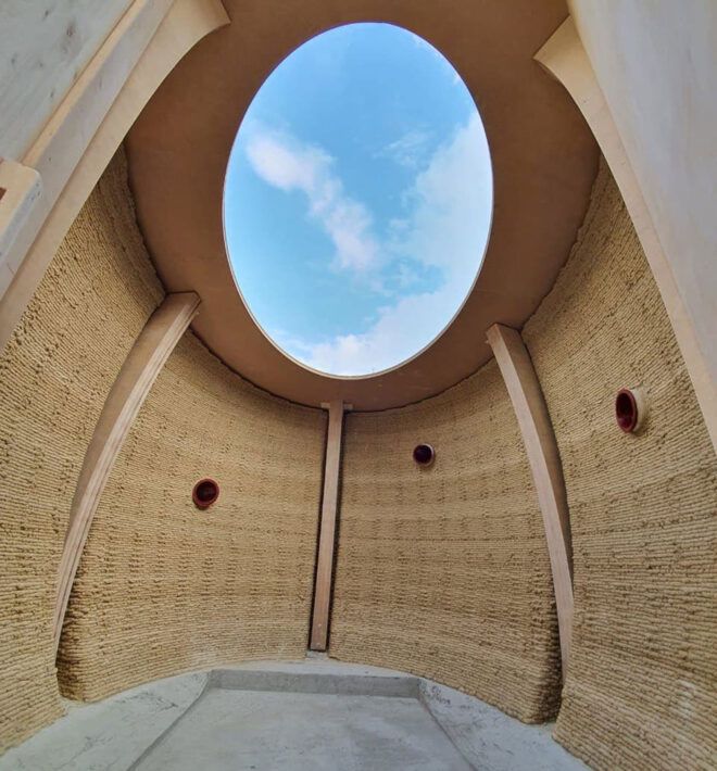 inside a small 3D-printed shelter with round skylight