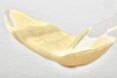 smeared beige eye cream on white background