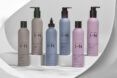 gray, blue and pink shampoo and conditioner bottles
