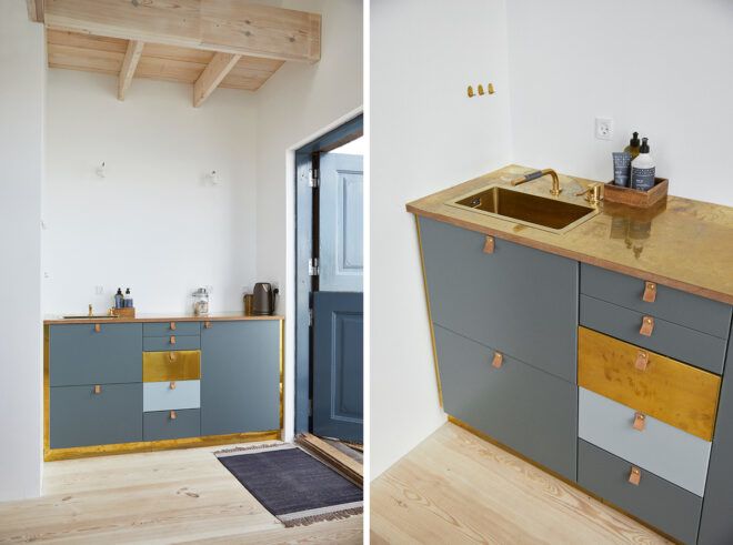 hotel kitchenette with small sink and gray cabinets