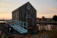 gabled wood tiny home with words 