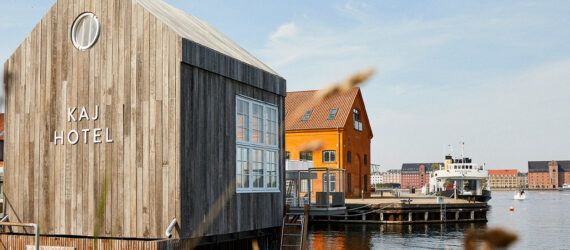 wooden tiny home floating on canal