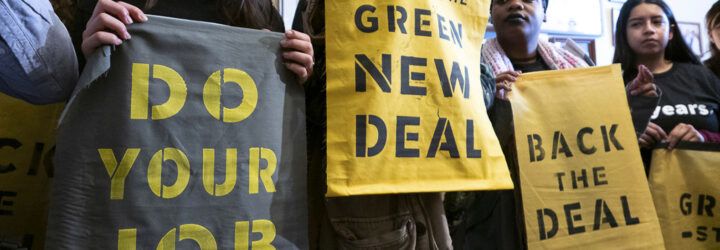A line of protestors holding signs that say 