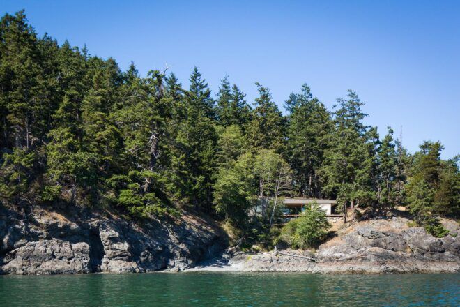 wood home tucked into coastal cliffside