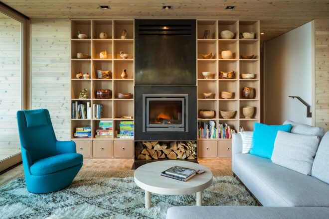 gray sofa and blue chair near wall with built-in wood shelving