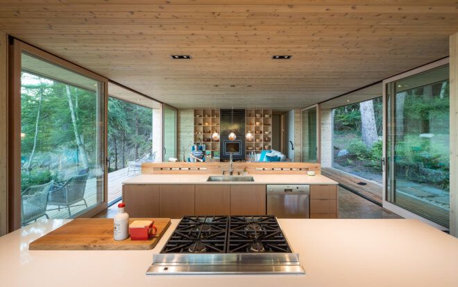 light wood kitchen in home with glass walls