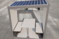 office pod with table and benches plus solar panels on roof