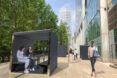 rendering of people working at covered tables in pods