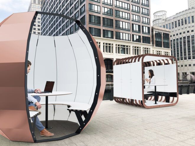 rendering of people working on computers inside gold and white pods