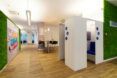 white office with accent walls covered in moss
