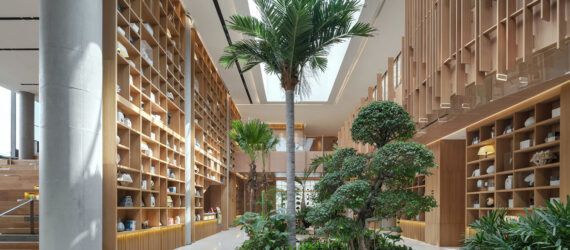 A plant-filled lobby with natural wood accents.