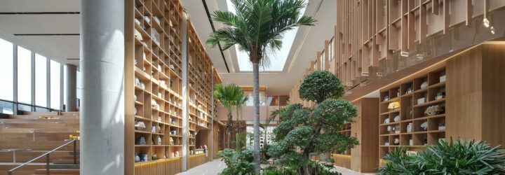 A plant-filled lobby with natural wood accents.