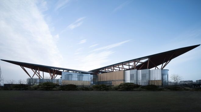 A landscape view of the building's exterior, showing an angular design at either end.