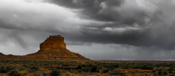 A desert with a cloudy, dark sky in New Mexico.