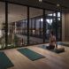 rendering of person on yoga mat in front of glass wall overlooking indoor garden