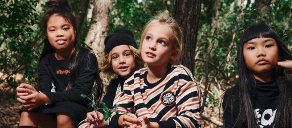 kids wearing black, white and orange clothes made from organic cotton