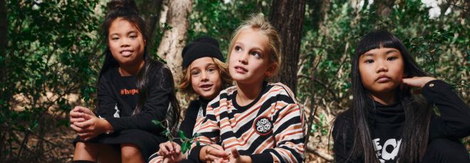 kids wearing black, white and orange clothes made from organic cotton