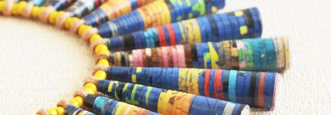 close up of necklace with beads made from tightly rolled comics