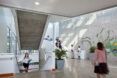 white lobby area with plants on walls