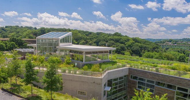 roof of building covered in plants and solar panels