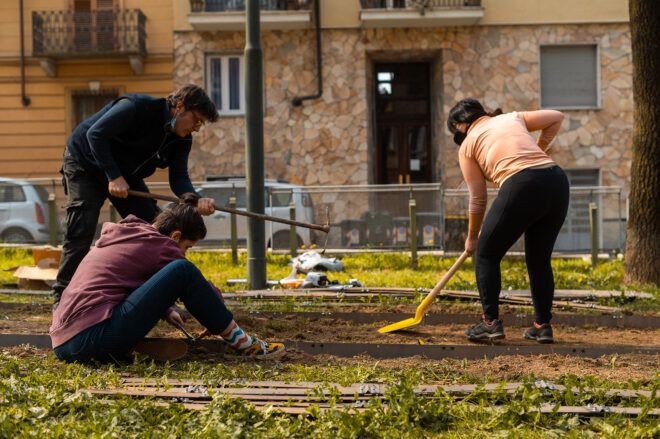people cleaning ground in a park