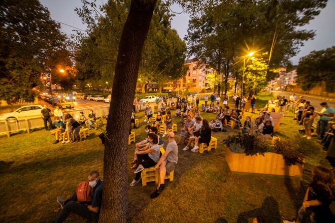 people sitting on seats in park at night