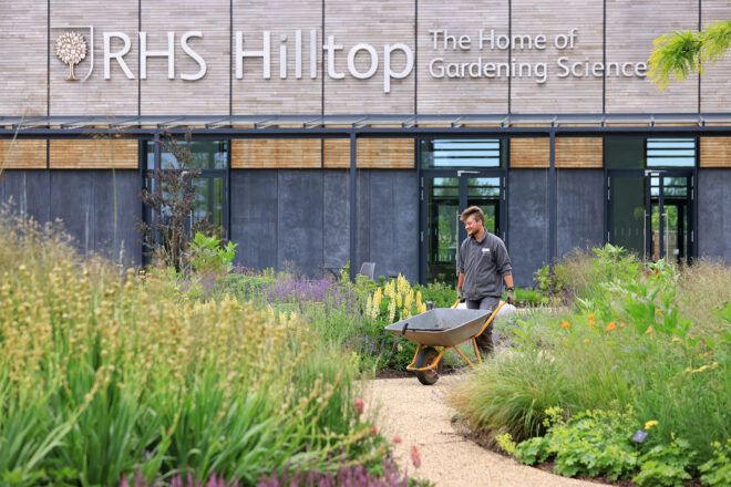 Aiden Couzens, horticulturalist, making final preparations to the Wellbeing Garden at RHS Hilltop.