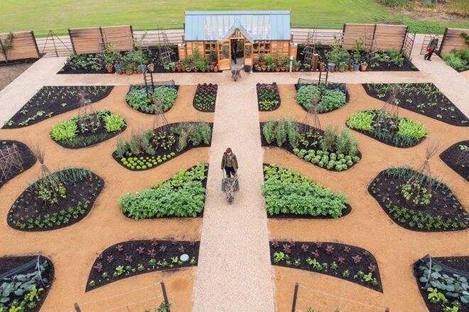 An overhead view of people tending to the World Food Garden at RHS Hilltop.