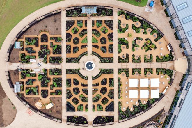 A bird's-eye view of the World Food Garden, showcasing an intricate design with a roundabout in the middle that branches of in four directions to different sections of the garden.