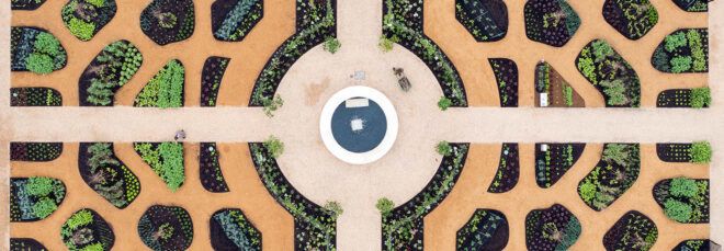 A bird's-eye view of the World Food Garden, showcasing an intricate design with a roundabout in the middle that branches of in four directions to different sections of the garden.