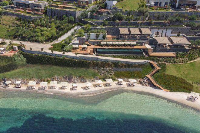 aerial view of hotel made up of various villas near beach