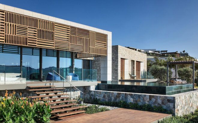 white villa with wood patterned screen over windows