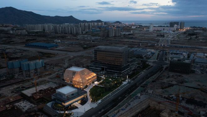aerial view of glass and wood building in a city under development