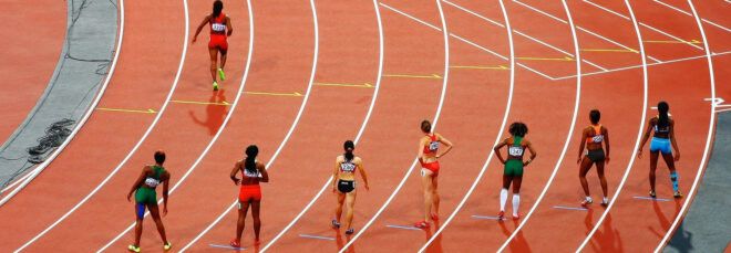 Eight runners on a running track.