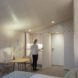 person opening doors to reveal a kitchenette inside a small cabin