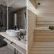 bathroom with dark gray tiles, light wood and sauna