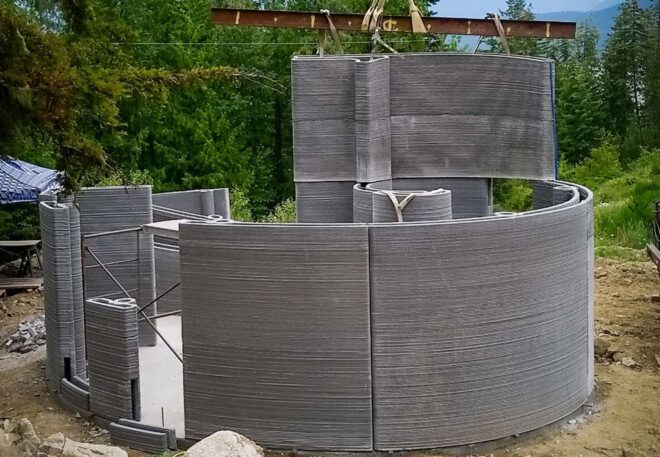 The curved concrete home being constructed.