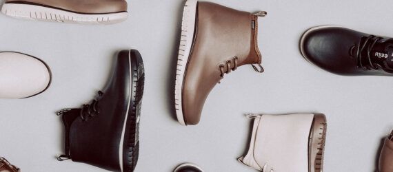 various vegan rain boots in neutral colors on a white background