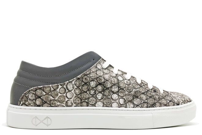 gray and white vegan shoe on white background