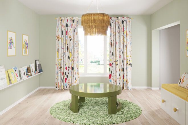 A playroom with green walls, a green rug and a green table in the middle of the room.
